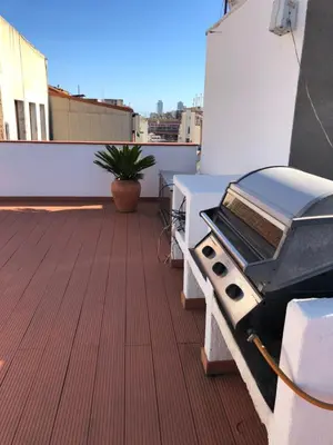 a bbq grill on the roof of a building at Attic Apartment 468 Sagrada Familia in Barcelona
