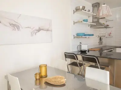 a kitchen with a table and chairs in a room at Attic Apartment 468 Sagrada Familia in Barcelona