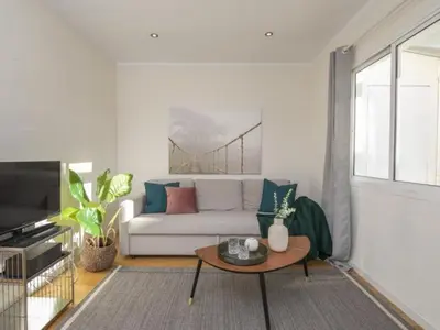 a living room with a white couch and a coffee table at Attic Apartment 468 Sagrada Familia in Barcelona