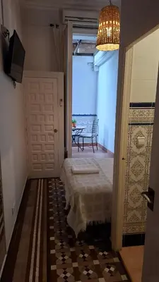a room with a door to a room with a table at Casa Consell Bailen, Guest House in Barcelona