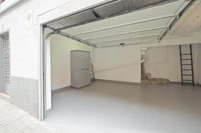 an empty garage with a refrigerator in a room at Bed&BCN Park Güell in Barcelona