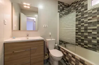 a bathroom with a toilet and a sink and a mirror at Bed&BCN Park Güell in Barcelona