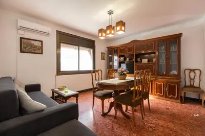 a living room with a couch and a table and chairs at Casa turística Cunit in Cunit