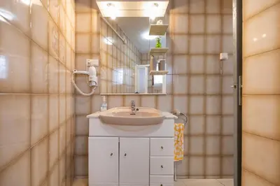 a bathroom with a sink and a mirror at Casa turística Cunit in Cunit