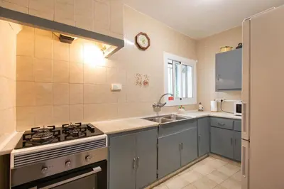 a kitchen with a stove and a sink at Casa turística Cunit in Cunit