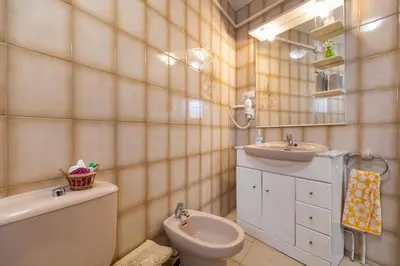 a bathroom with a toilet and a sink at Casa turística Cunit in Cunit