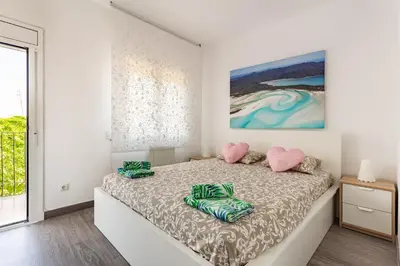 a bedroom with a bed with two heart cushions at Barca 3 New Lovely aprtment Near Beach in Sant Adria de Besos