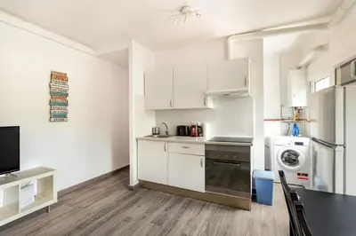 a kitchen with white cabinets and a sink and a dishwasher at Barca 3 New Lovely aprtment Near Beach in Sant Adria de Besos