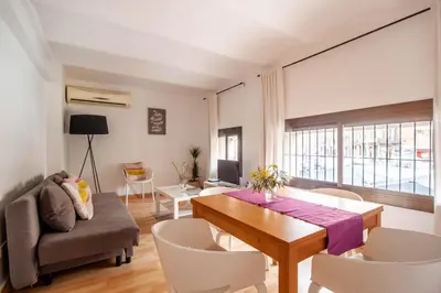 a living room with a dining room table and chairs at Apartamento zona Sagrada Familia in Barcelona
