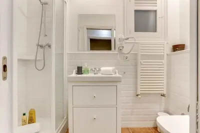 a white bathroom with a sink and a shower at Casa Cosi - Putxet 3 in Barcelona