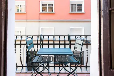 a table and chairs on a balcony with a building at Casa Cosi - Putxet 3 in Barcelona