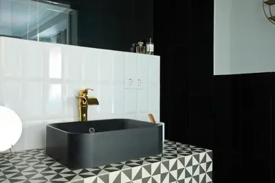 a black and white bathroom with a black tub at Casa Cosi - Terrace 1 in Barcelona