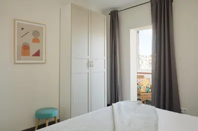 a bedroom with a bed and a chair and a window at Casa Cosi - Terrace 2 in Barcelona