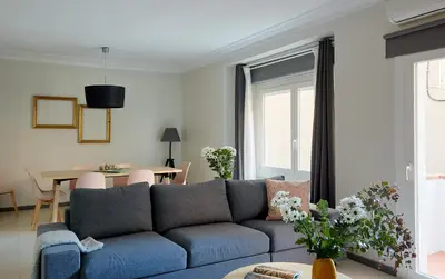 a living room with a blue couch and a table at Casa Cosi - Casanova 1 in Barcelona