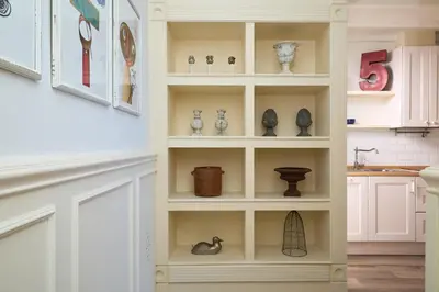 a white book shelf with vases and other items at Casa Cosi - Patio 2 in Barcelona