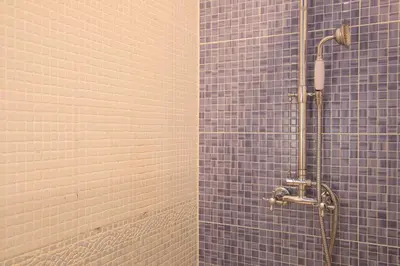 a blue tiled bathroom with a shower with blue tiles at Casa Cosi - Patio 2 in Barcelona