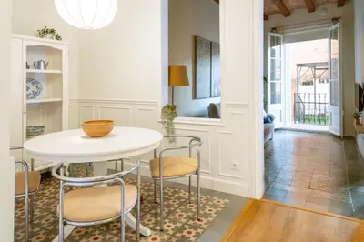 a dining room with a white table and chairs at Casa Cosi - Putxet 1 in Barcelona