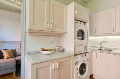 a kitchen with a dishwasher and a bowl of fruit on a counter at Casa Cosi - Sant Gervasi 2 in Barcelona