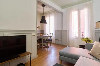 a living room with a couch and a television at Casa Cosi - Sant Gervasi 2 in Barcelona