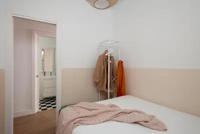 a bedroom with a bed with a towel on it at Casa Cosi - Sant Gervasi 4 in Barcelona