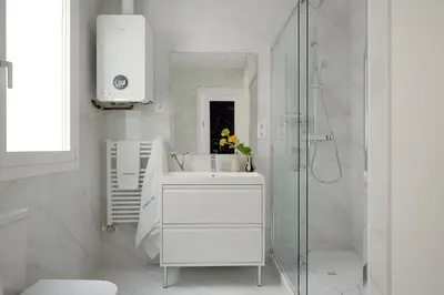 a white bathroom with a sink and a shower at Casa Cosi - Sant Gervasi 4 in Barcelona