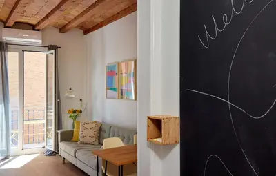 a living room with a chalkboard on the wall at Casa Cosi - Sant Gervasi 4 in Barcelona