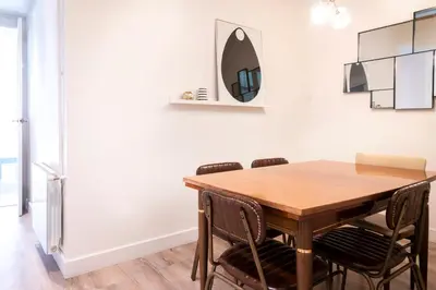 a dining room with a wooden table and chairs at Casa Cosi - La Gleva 4 in Barcelona