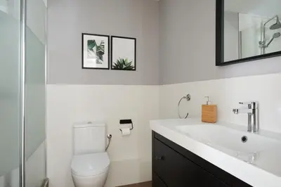 a bathroom with a toilet and a sink at Casa Cosi - Casanova 7 in Barcelona