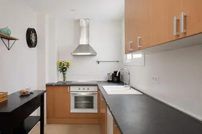 a kitchen with a sink and a stove at Casa Cosi - Casanova 7 in Barcelona