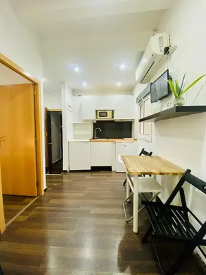 a living room with a table and a kitchen at 09 Apartament born 4 2 in Barcelona