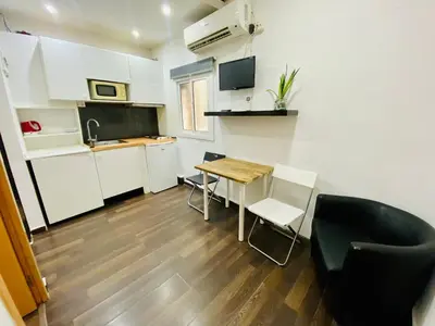 a small kitchen with a table and chairs in a room at 09 Apartament born 4 2 in Barcelona