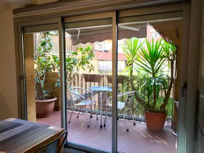a balcony with a table and chairs and plants at Rosselló Apartment in Barcelona