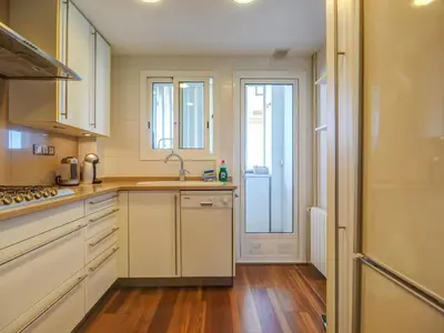 a kitchen with white cabinets and a sink at Balmins Surf by Hello Homes Sitges in Sitges