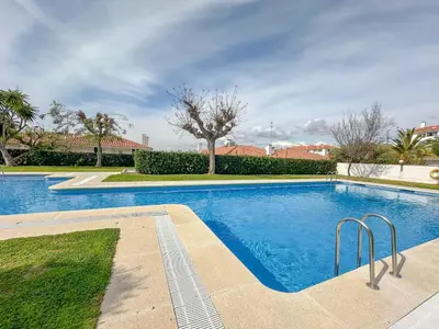 a swimming pool in a yard with trees and bushes at Balmins Surf by Hello Homes Sitges in Sitges