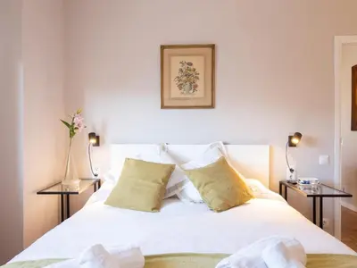 a bedroom with a white bed with two side tables at Clot market in Barcelona