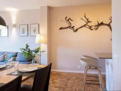 a dining room with a dining table and a branch on the wall at Clot market in Barcelona