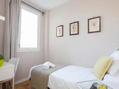 a small room with a bed and a window at Clot market in Barcelona