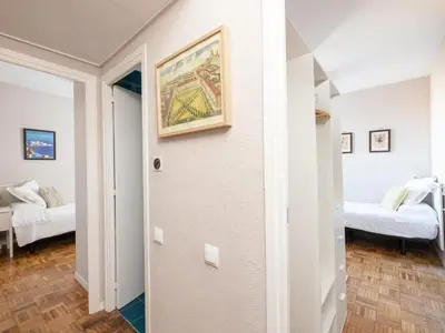 a room with two beds and a painting on the wall at Clot market in Barcelona