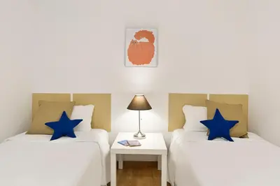 two beds in a room with blue stars at Sardenya Apartment by Olala Homes in Barcelona