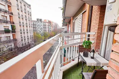 a balcony with a table and a view of a city at Love Local Life Near Sagrada Familia by MyRentalHost in Barcelona