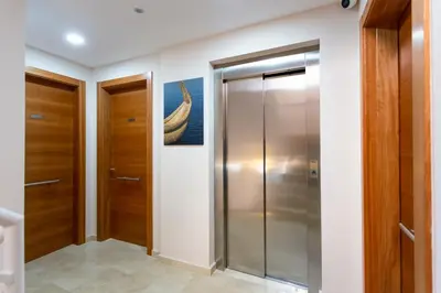 a walk in shower in a bathroom with wooden doors at 8 lacus in Hospitalet de Llobregat