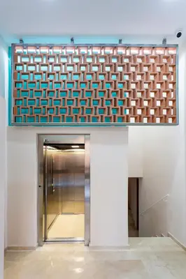 a elevator in a building with a blue and white wall at 8 lacus duplex in Hospitalet de Llobregat