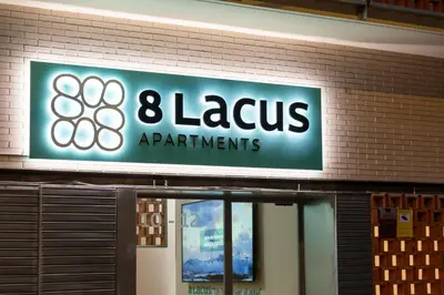 a sign on a building that says lazarus apartments at 8 lacus VICTORIA in Hospitalet de Llobregat