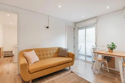 a living room with a couch and a table at Feel Welcome Barcelona Smart flat in Cornellà de Llobregat