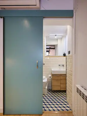 a door to a bathroom with a toilet and a sink at Casa Wilson by MyRentalHost in Barcelona