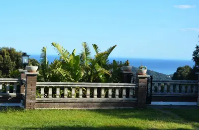 a fence with the ocean in the background at Sea view, Wonderful pool, Nature, Peaceful & AC in Sant Cebrià de Vallalta