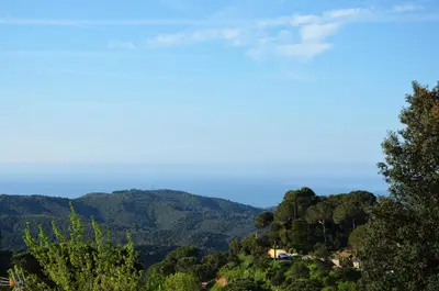 a view of the mountains with a house on a hill at Sea view, Wonderful pool, Nature, Peaceful & AC in Sant Cebrià de Vallalta