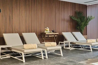 a row of chaise lounge chairs in a room at Hotel Marina Badalona in Badalona