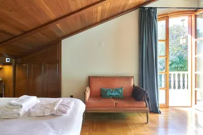 a bedroom with a bed and a bench with a green pillow at Villa Marco in Canyelles