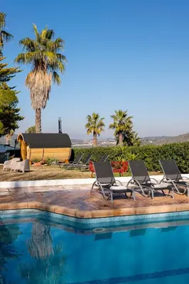 a group of chairs sitting next to a swimming pool at Villa Marco in Canyelles